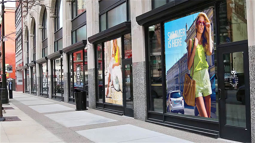 Full-color adhesive vinyl graphics applied across a row of storefront windows