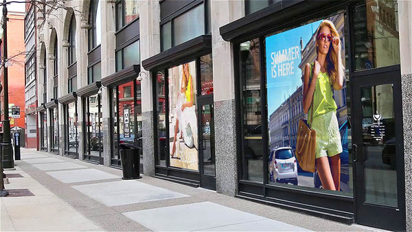Full-color adhesive vinyl graphics applied across a row of storefront windows