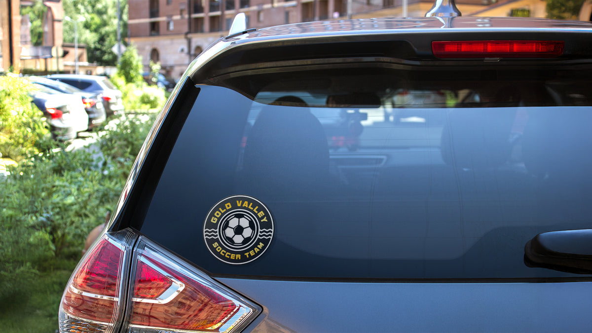 Round adhesive vinyl decal applied to a car's rear window