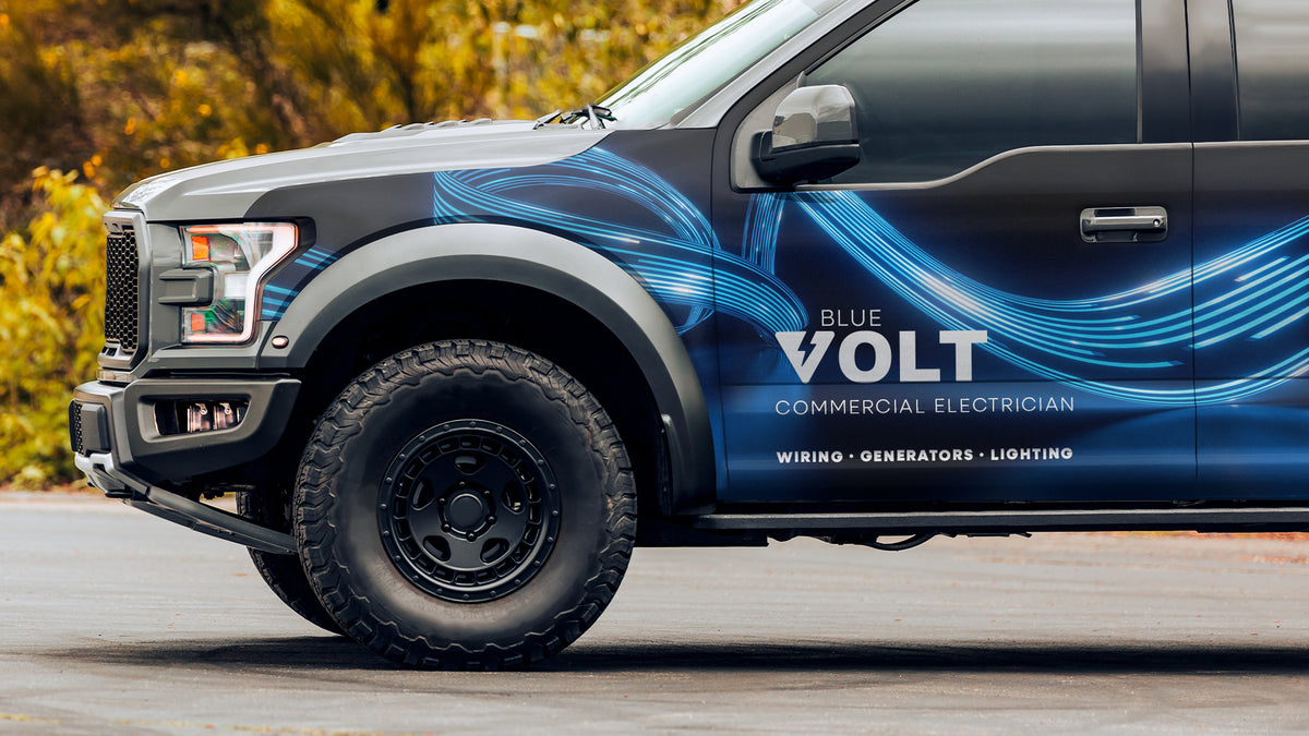 Pickup truck with a full-side printed wrap, the film following body contours and wheel arches
