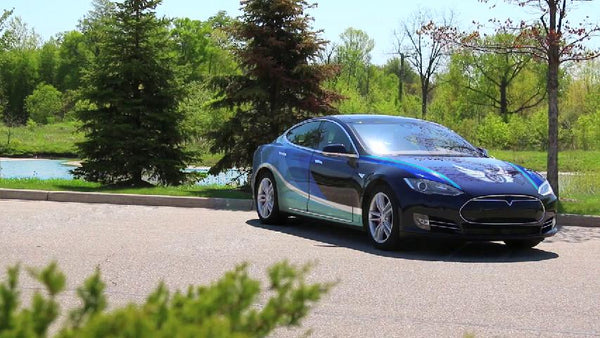 Car finished in a full-color printed wrap film, parked outdoors