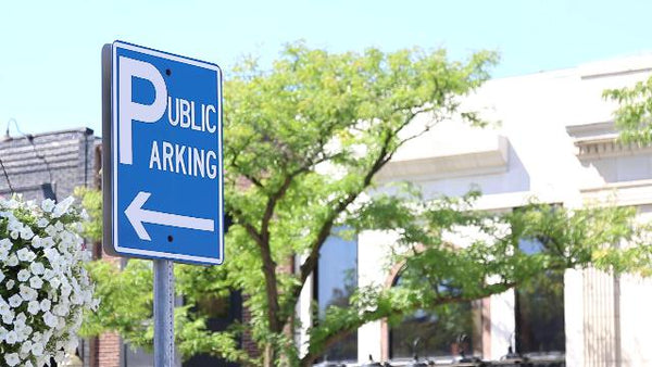 Aluminum sign mounted on a metal pole as a directional parking sign in a downtown streetscape
