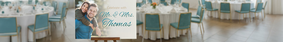 Wide foam board event welcome sign displayed on a wooden easel at a reception venue