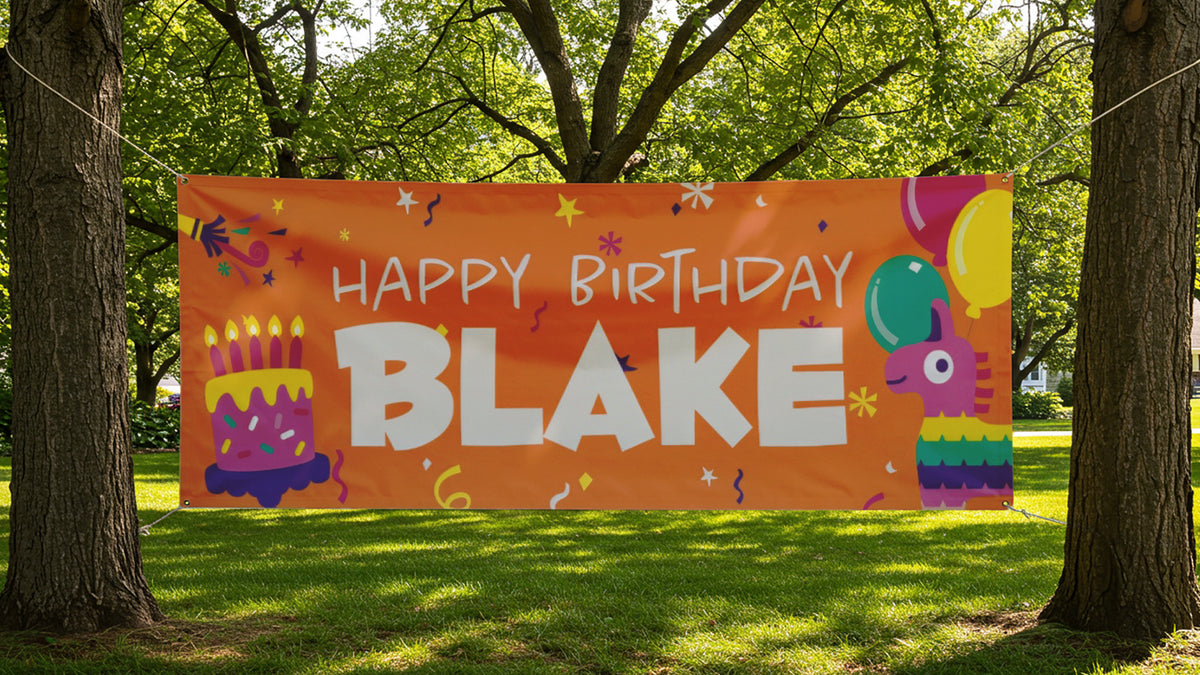 Full-color vinyl banner with grommets, rope-hung between two trees over a lawn