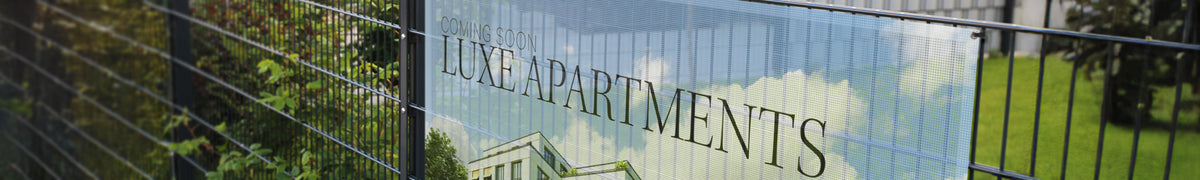 Wide mesh banner attached to a wire fence, showing how the perforated material passes wind